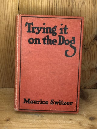 Item #006655 TRYING IT ON THE DOG. Maurice Switzer