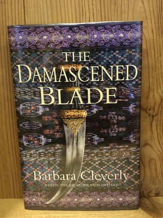 Item #501052 The Damascened Blade. Barbara Cleverly